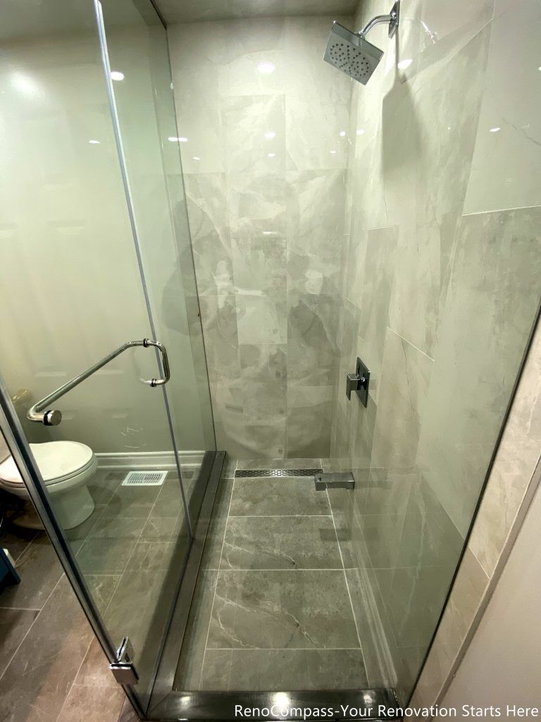 This Mississauga bathroom renovation features a walk-in shower with full-height tile walls, a clear glass enclosure, and a linear floor drain. The layout prioritizes water control, ease of cleaning, and everyday comfort while keeping the shower area visually clean and well-defined. Neutral tones and simple hardware complete the modern, practical design.
City: Mississauga · Toronto contractor: Reno Compass