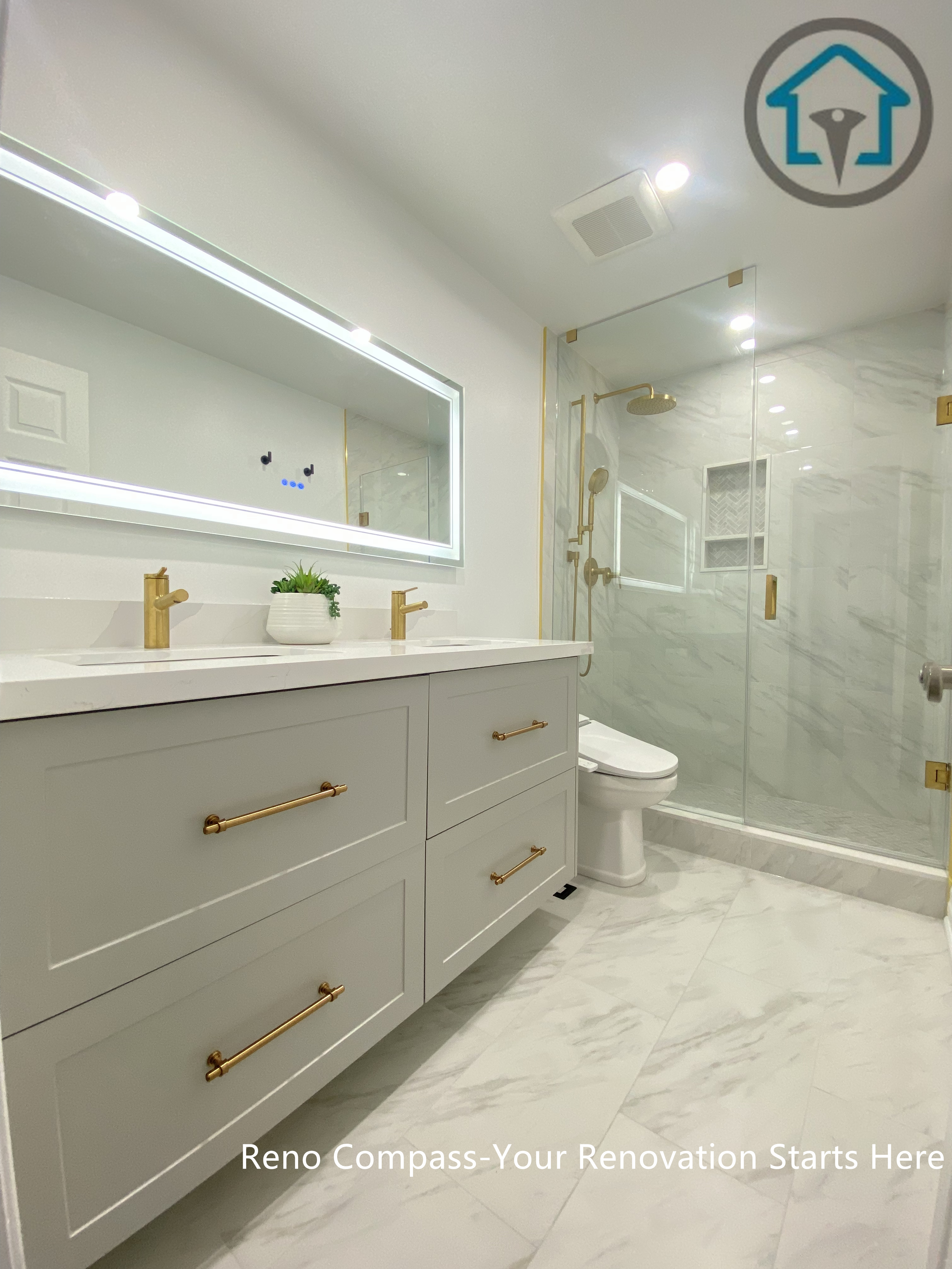 This Pickering bathroom renovation features a custom double vanity designed for both storage efficiency and everyday comfort. Clean-lined white cabinetry is paired with matte black handles for subtle contrast, while the integrated LED mirror provides even lighting and visual depth. The layout keeps the space organized and functional without compromising on a clean, modern aesthetic.