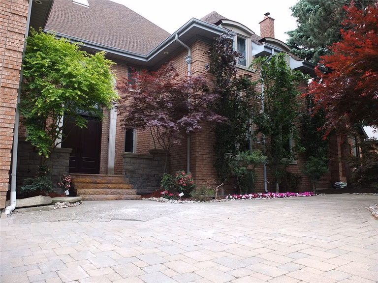 This Richmond Hill front entrance renovation showcases a newly installed interlocking stone porch with durable natural-tone tiles and clean modern finishing. The upgraded entrance landing improves safety, drainage, and curb appeal while complementing the home’s brick exterior and stone pillars. Completed by a trusted Toronto renovation company, this landscaping and interlocking project delivers a refined, long-lasting front entry designed for both functionality and visual impact.
