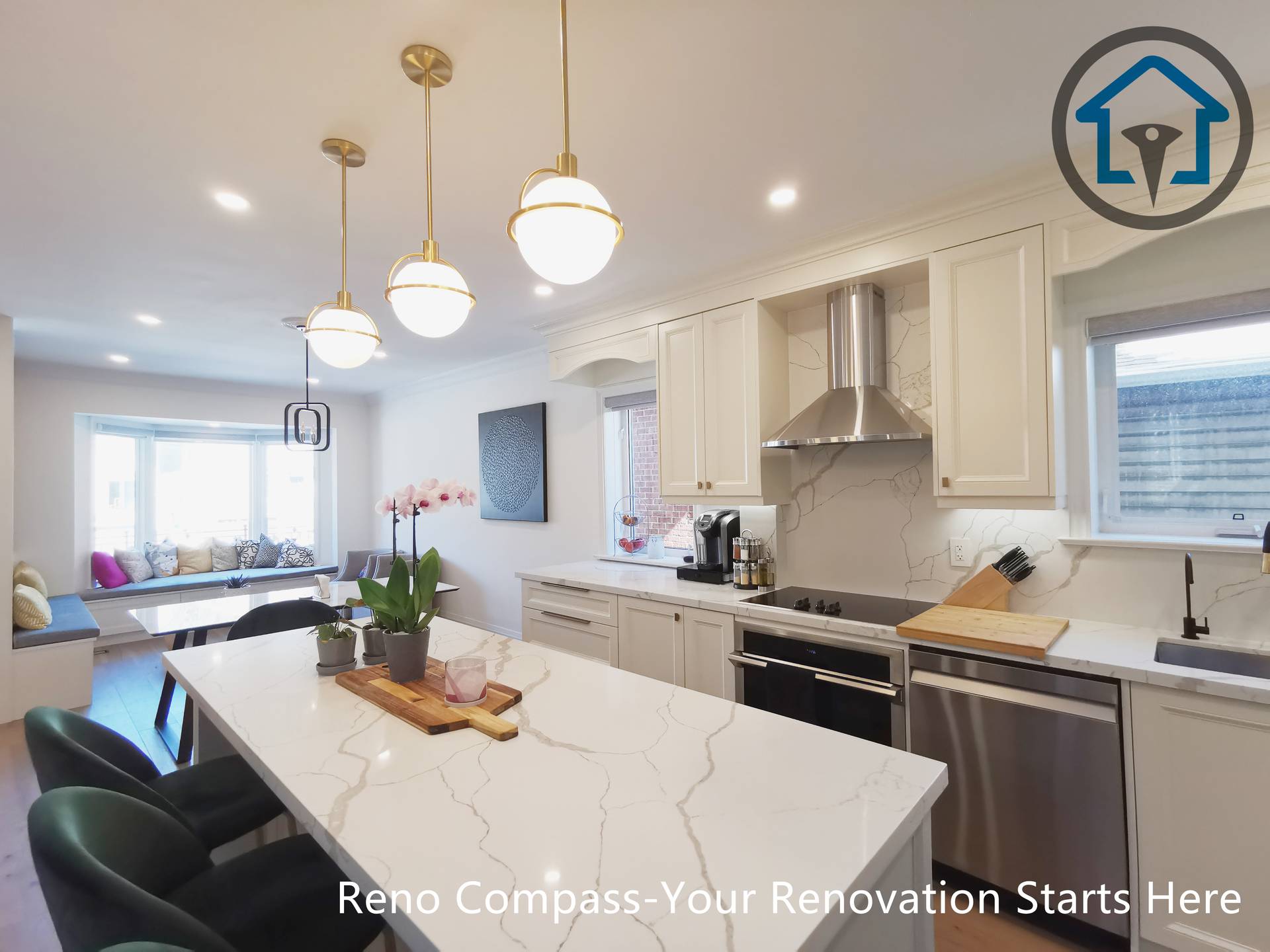 This image features the main kitchen island from a North York interior renovation, highlighting a large quartz countertop paired with elegant pendant lighting. The island provides generous seating and prep space, serving as the functional and visual center of the kitchen. White shaker cabinetry, stainless steel appliances, and a modern range hood create a clean, cohesive look, while the open sightline connects the kitchen seamlessly to the adjacent living area. Warm hardwood flooring balances the bright finishes and enhances overall comfort. Completed by a Toronto renovation company, this kitchen renovation emphasizes usability, material quality, and a refined open-concept layout.