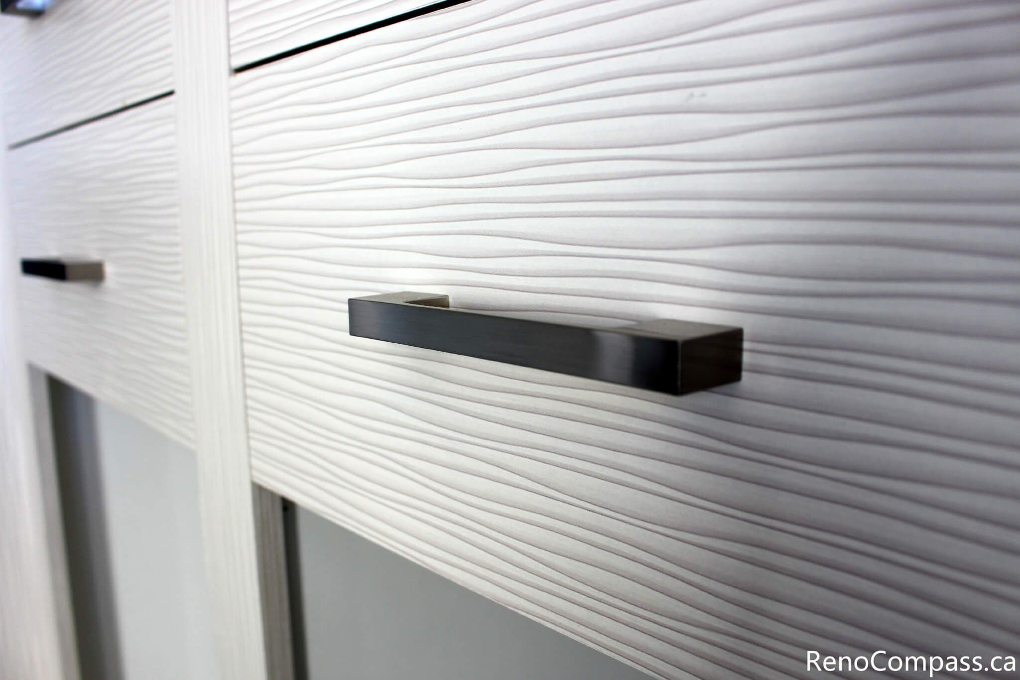 This close-up cabinet detail highlights the custom storage installed during a full house renovation in Mississauga by a professional Toronto renovation company. Featuring textured cabinet panels and sleek modern handles, the design adds both visual interest and functionality to the interior space. The renovation focuses on high-quality craftsmanship, contemporary finishes, and practical storage solutions that enhance everyday living and overall home value.