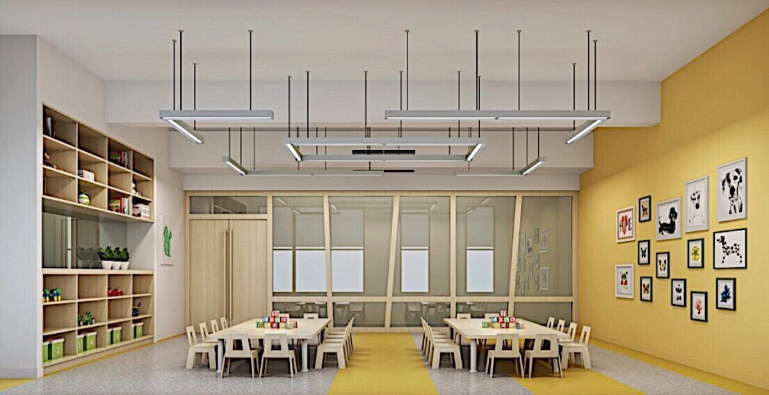 This Toronto daycare classroom renovation features a bright and thoughtfully designed learning environment tailored for young children. The space highlights warm yellow accent walls, custom built-in storage shelving, and child-sized tables arranged for collaborative learning. Suspended modern lighting enhances brightness while maintaining a clean, contemporary look. Large interior glass partitions allow natural light to flow through the space, creating an open and welcoming atmosphere.

Designed with safety, functionality, and creativity in mind, this kindergarten renovation project reflects a professional commercial daycare interior upgrade in Toronto, combining educational efficiency with modern design aesthetics.