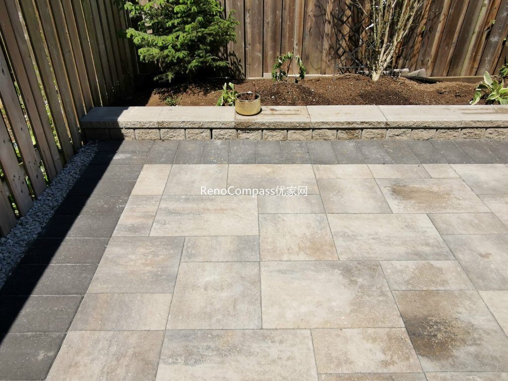 This Mississauga backyard renovation showcases a professionally installed interlocking stone patio with clean modern lines and a raised garden retaining wall. Large-format pavers create a durable and elegant outdoor flooring solution, while the stone border and planting area add depth and structure to the landscape. Completed by an experienced Toronto renovation and landscaping team, this project enhances outdoor usability, drainage, and long-term property value with low-maintenance, high-quality materials.