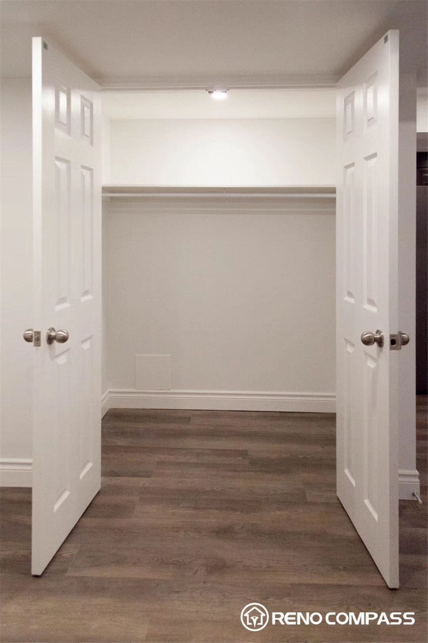This Markham basement renovation features a clean and functional walk-in closet space designed to maximize storage and organization. The project includes newly installed double doors, fresh neutral wall finishes, modern flooring, and upgraded lighting to create a bright and practical storage area. The open closet layout allows for flexible shelving and hanging space, making the basement more livable and organized. Completed by Reno Compass Inc., this basement renovation in Markham focuses on both functionality and clean modern design, enhancing everyday usability while maintaining a polished interior look.
