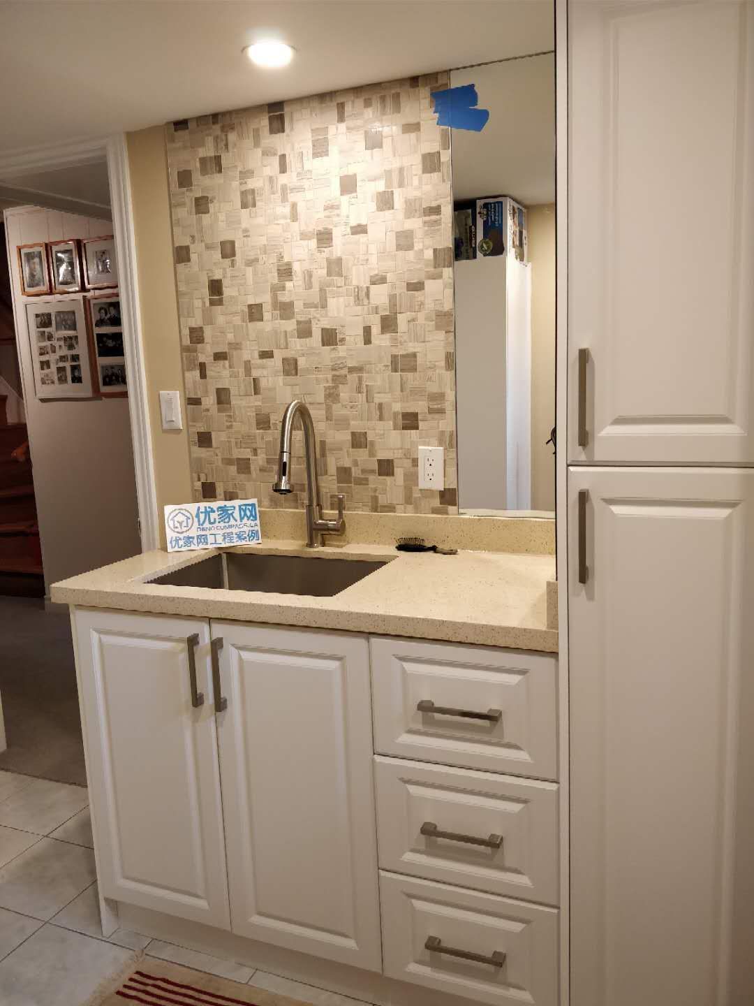 A professional basement transformation by Reno Compass in Scarborough. This project highlights modern space-saving solutions, including a custom wet bar and premium cabinetry installations.