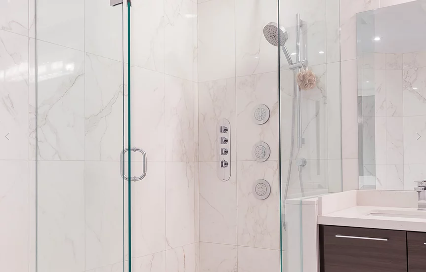 A spa‑inspired bathroom from our Vaughan full house interior renovation featuring a frameless glass shower, marble‑look wall tiles, rainfall showerhead, and a sleek vanity. This elegant upgrade combines modern design with premium finishing details for a calm and refreshing space.
