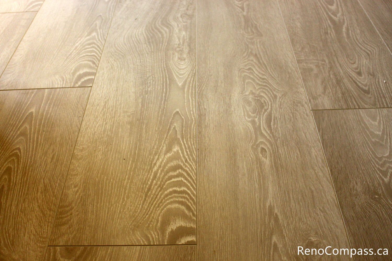 High-quality wide-plank wood-look flooring and custom baseboard installation for an interior renovation in Oshawa, Ontario. Professional craftsmanship by RenoCompass.ca to enhance home value and modern aesthetics.