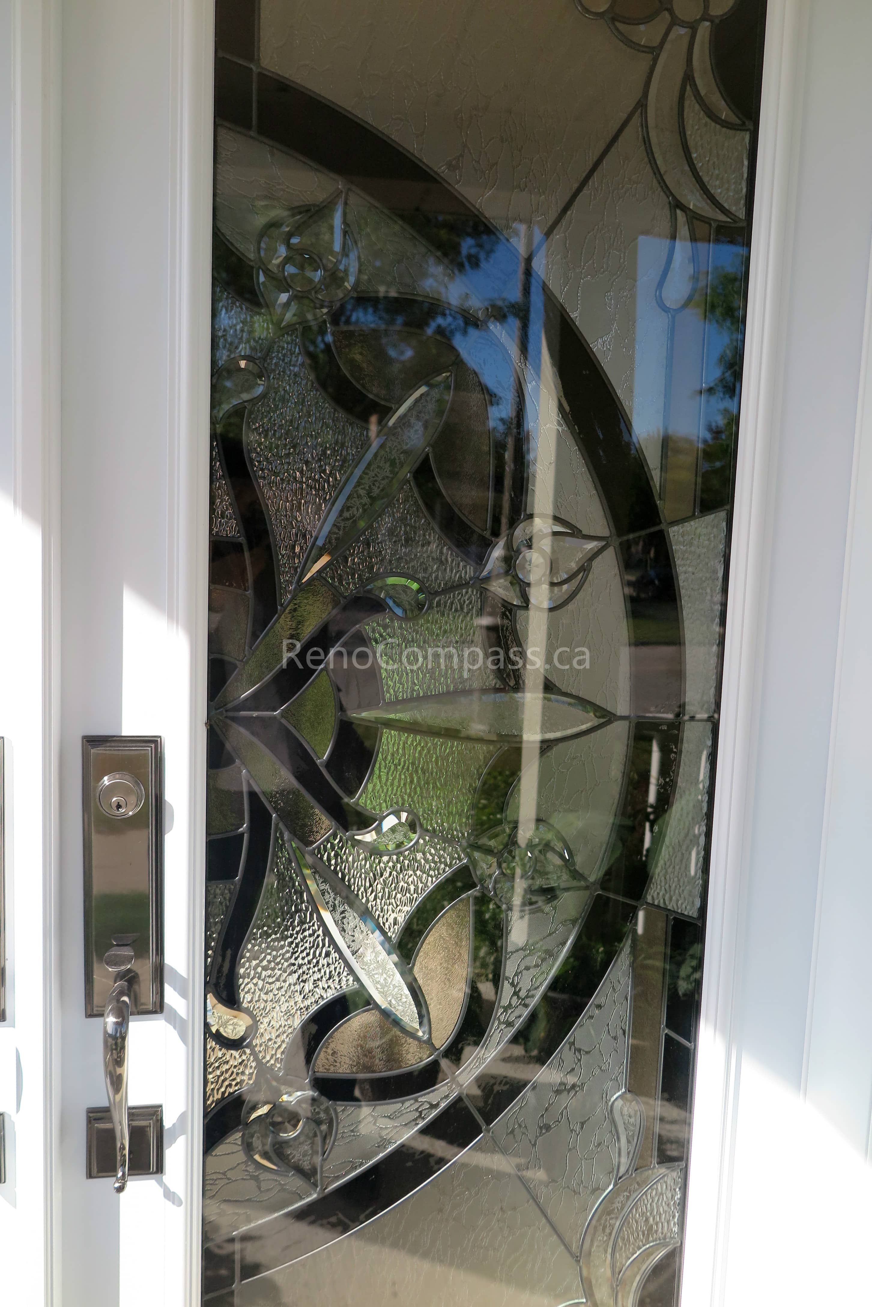 Close-up detail of newly installed double entry door hardware in a Newmarket home, featuring modern black handles and secure locking systems paired with decorative privacy glass panels. Completed by a professional Toronto Renovation Company, this door upgrade enhances both security and visual appeal while adding a refined, high-end finish to the home’s main entrance.