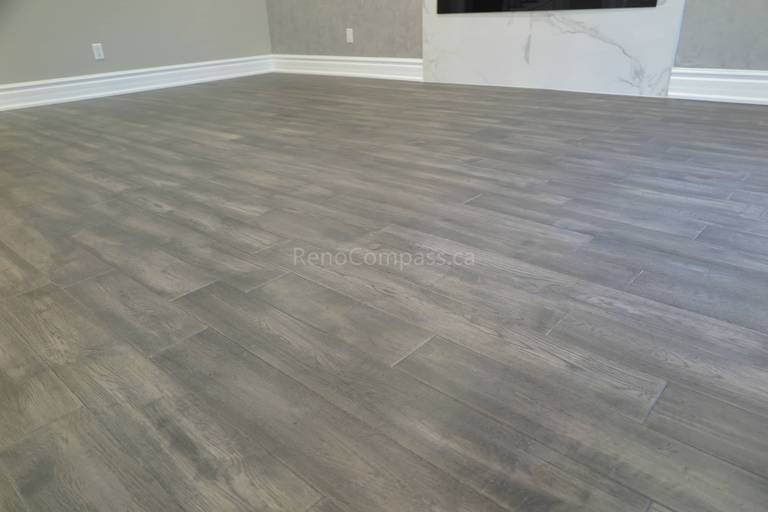 This Markham interior renovation highlights newly installed modern vinyl flooring with a natural wood-grain finish, designed for durability and contemporary style. The flooring enhances the open living space while complementing neutral wall tones, clean baseboard trim, and modern interior finishes. Completed by Reno Compass, a professional renovation contractor specializing in flooring installation and full interior renovations across Markham and the Greater Toronto Area.