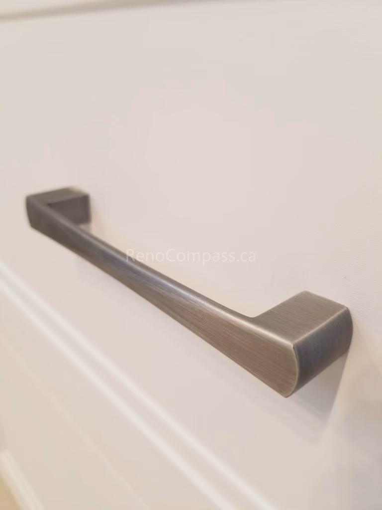 This Mississauga interior renovation detail highlights modern brushed nickel cabinet hardware installed on custom cabinetry. The sleek handle design adds a clean, contemporary touch while improving functionality and durability for everyday use.

Installed by Reno Compass Inc., this refined finishing detail enhances the overall quality and modern aesthetic of the renovated kitchen and bathroom spaces.