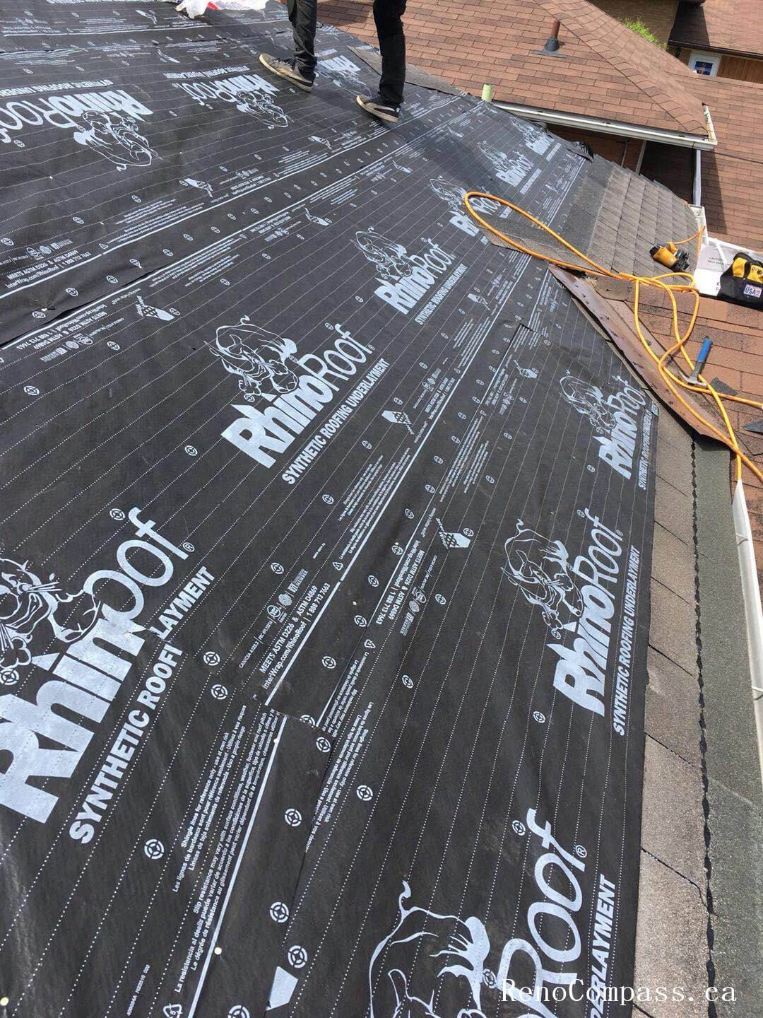 This image captures the mid-stage of a roofing replacement project in Toronto, showing newly installed roof decking and waterproof underlayment preparation. The old roofing materials have been removed to expose the wooden roof structure, allowing the team to reinforce the base and ensure proper alignment before installing new shingles. High-quality waterproof membrane layers are applied to enhance moisture protection and improve long-term durability against Toronto’s harsh weather conditions. This professional roofing replacement process ensures structural integrity, proper insulation support, and a reliable foundation for the final roofing system installation on residential properties.
