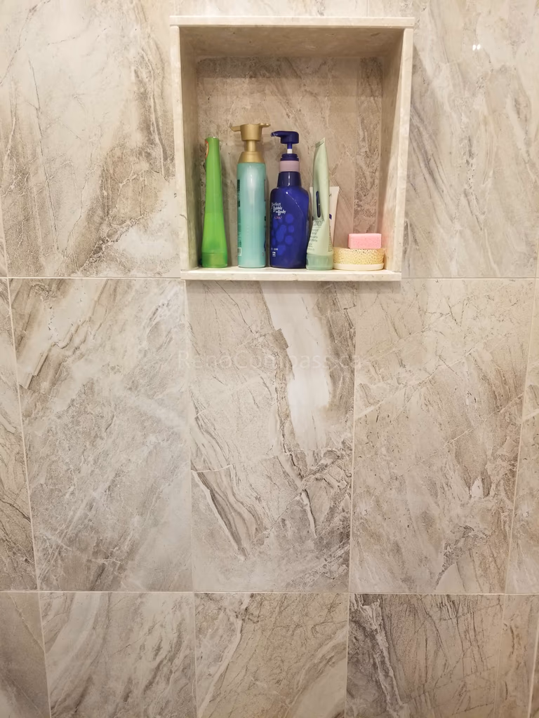 This Markham bathroom renovation features newly installed shower wall tiles with a built-in recessed niche for convenient storage. The modern tile design enhances both functionality and visual appeal, providing a clean, elegant finish that is easy to maintain. As part of a full bathroom upgrade including new flooring, shower, and vanity, the space now offers improved comfort, durability, and a contemporary look for everyday use.
