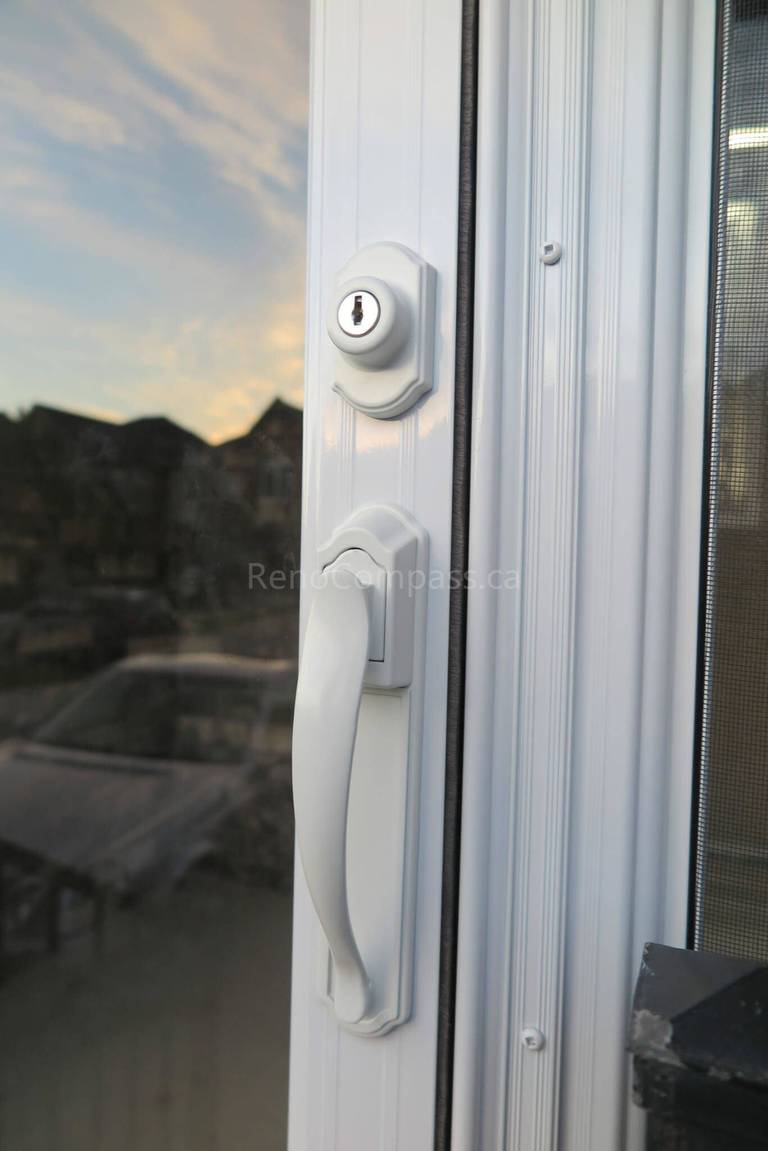 Close-up detail of the door handle and lock system from a Markham storm door installation completed by  Reno Compass Inc. The elegant white finish and premium hardware ensure smooth operation, strong security, and a clean modern look for the home exterior.
