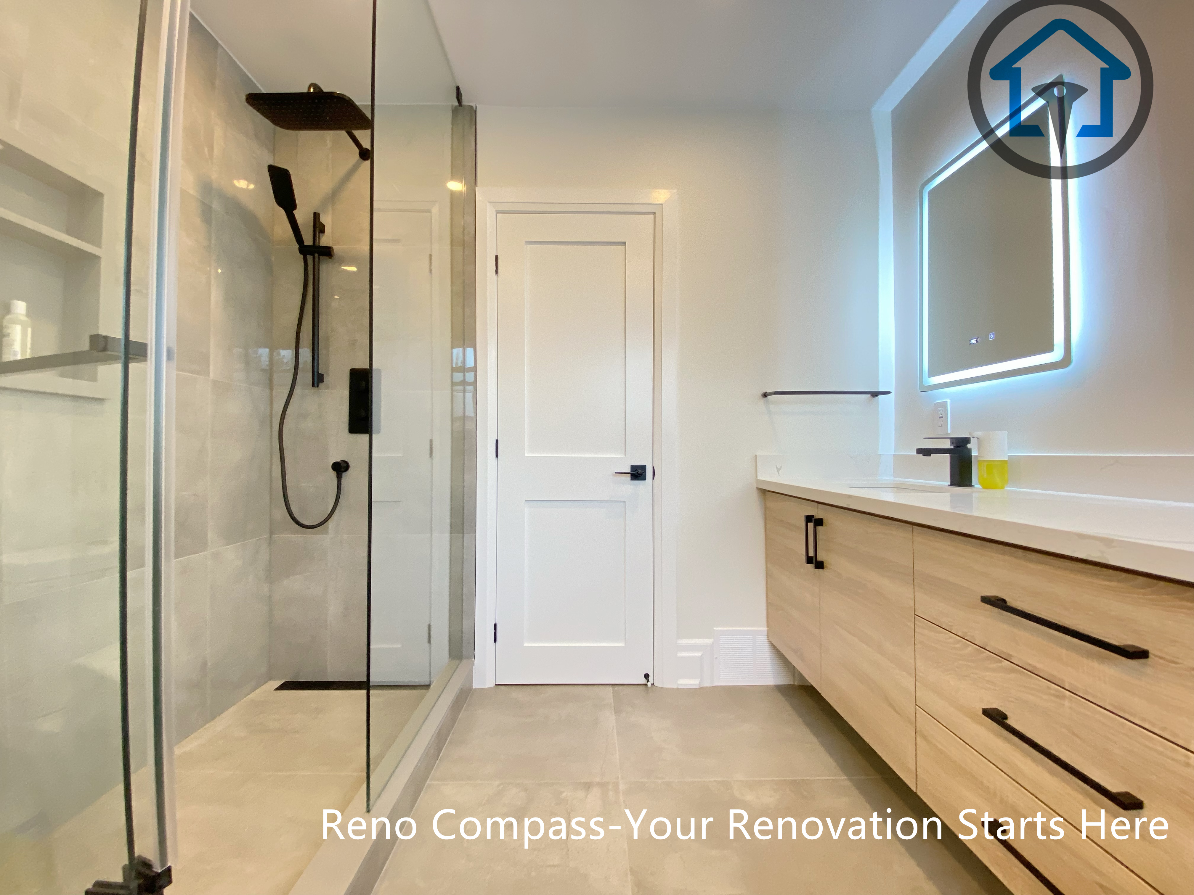 This North York house bathroom renovation features a clean, linear layout with a walk-in glass shower and a custom wood vanity. Neutral tile finishes, black fixtures, and integrated lighting create a modern, well-balanced space that prioritizes daily comfort, storage efficiency, and long-term usability.