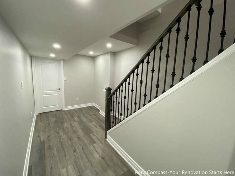 This Oakville basement renovation features a clean and modern staircase landing with upgraded flooring, fresh wall finishes, and recessed pot lighting that brightens the entire lower level. The redesigned layout improves flow between rooms while maintaining a simple and contemporary aesthetic. Completed by a professional Toronto renovation company, this basement upgrade enhances functionality, lighting, and durability, creating a polished and comfortable finished space that adds long-term value to the home.