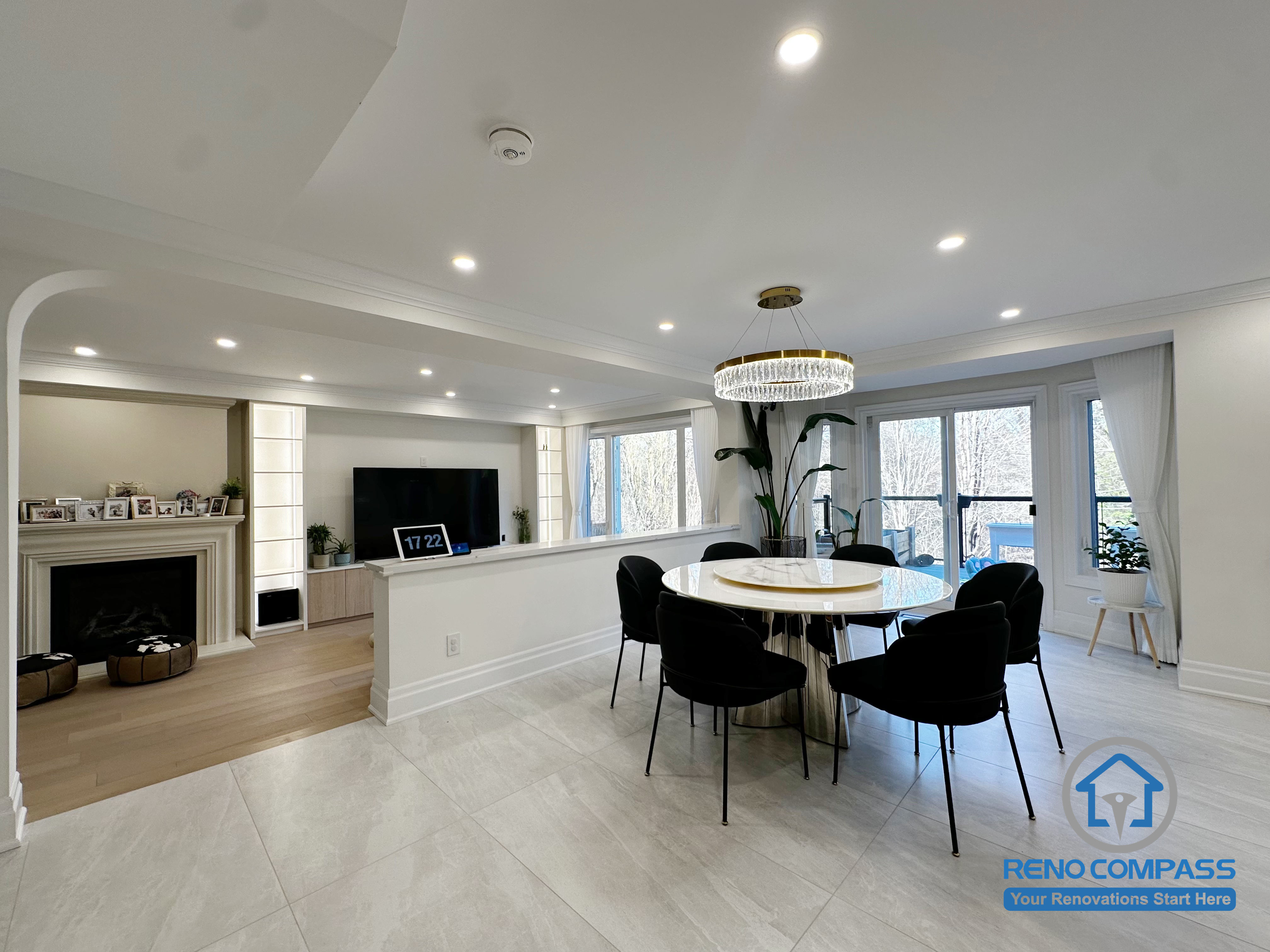 This Markham interior renovation reimagines the relationship between the living and dining areas through a clean, open layout that supports both daily use and social gatherings. The dining space is positioned to connect naturally with the living area, creating a continuous flow while maintaining clear functional boundaries.

Carefully planned ceiling details and recessed lighting help unify the space, while consistent flooring transitions enhance visual cohesion across different zones. Large windows allow natural light to fill the interior, making the overall environment feel bright, balanced, and welcoming throughout the day.

The result is a refined interior layout that emphasizes comfort, flexibility, and long-term livability—designed to suit modern family life in Markham.