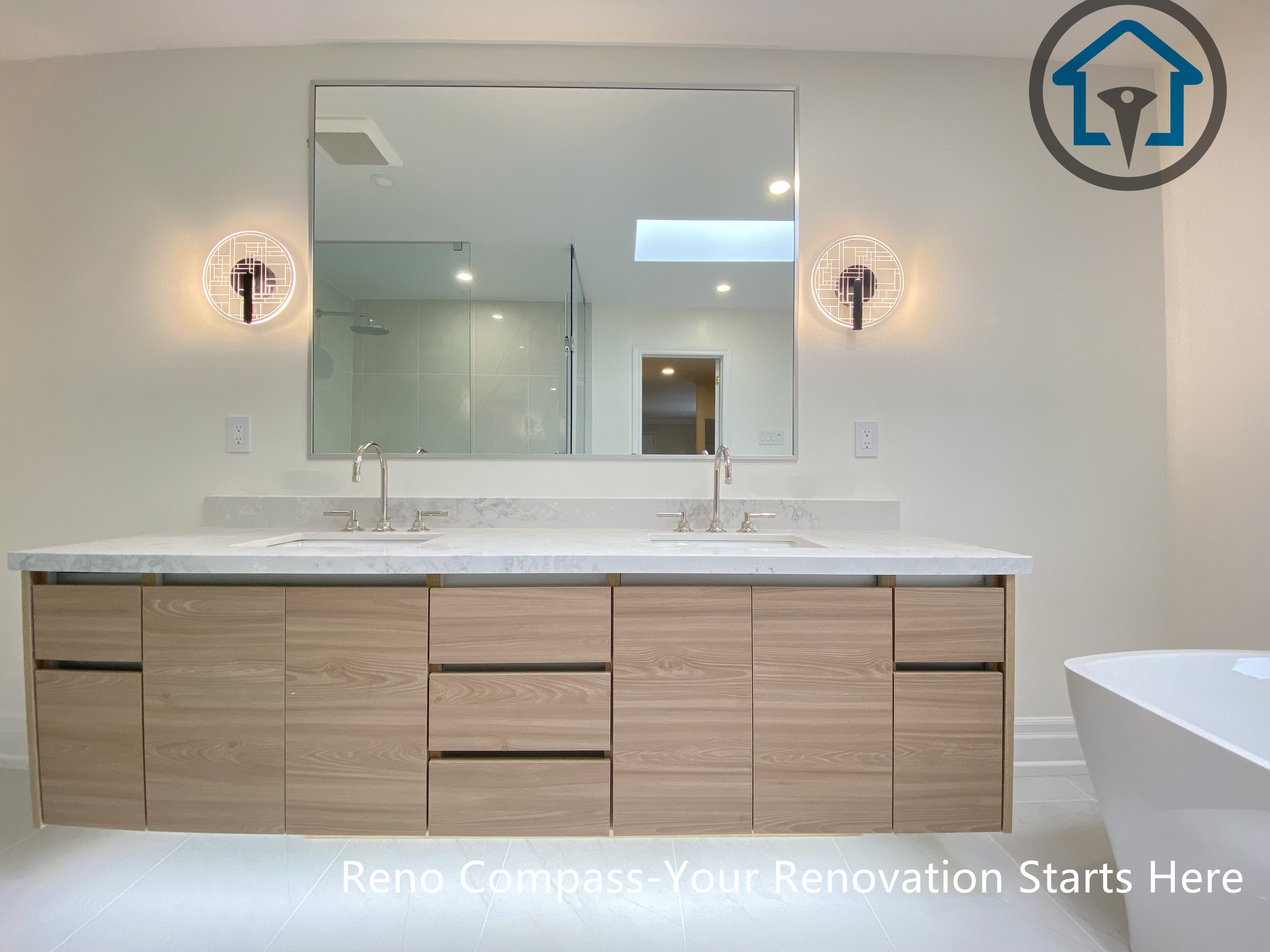 This bathroom renovation features a custom double vanity with integrated lighting, paired with a freestanding bathtub to create a bright and balanced layout. Designed for both functionality and visual clarity in a Thornhill home by Reno Compass.