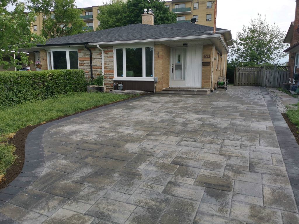 Residential driveway interlocking project in North York showcasing concrete paver installation, smooth surface transitions, and a clean exterior layout designed to enhance curb appeal and durability.