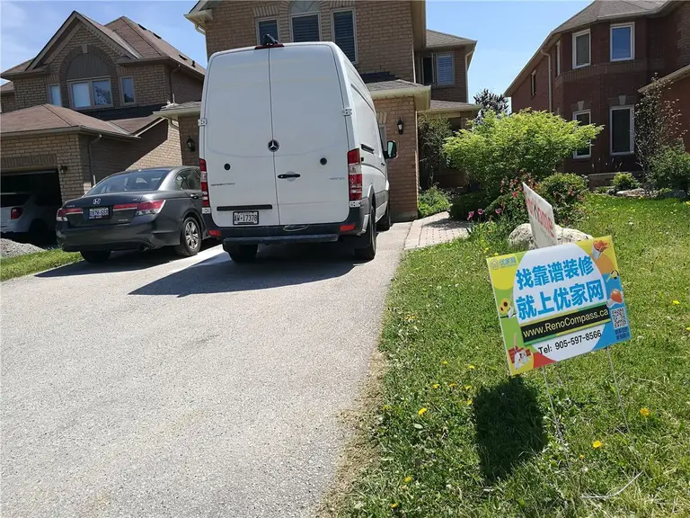 Modernized home exterior in Richmond Hill showcasing fresh paint, upgraded entryway, and improved curb appeal. Part of a full interior and exterior renovation completed by Reno Compass.