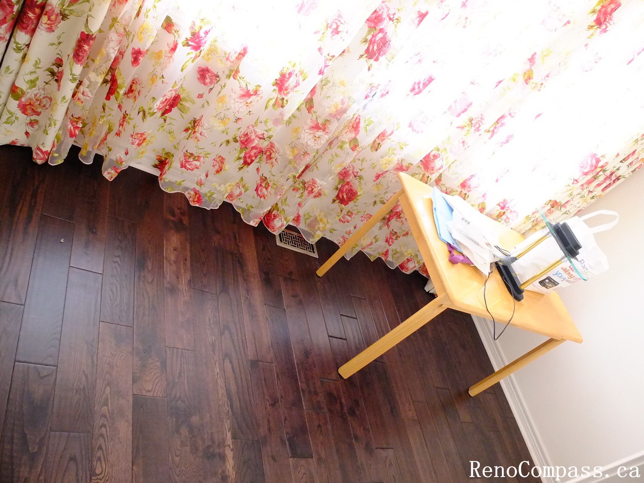 Toronto home hardwood flooring installation featuring deep-toned wood floors throughout the hallway and upper level. This professional flooring renovation enhances brightness, durability, and visual continuity, completed by Reno Compass for a clean and modern interior upgrade.