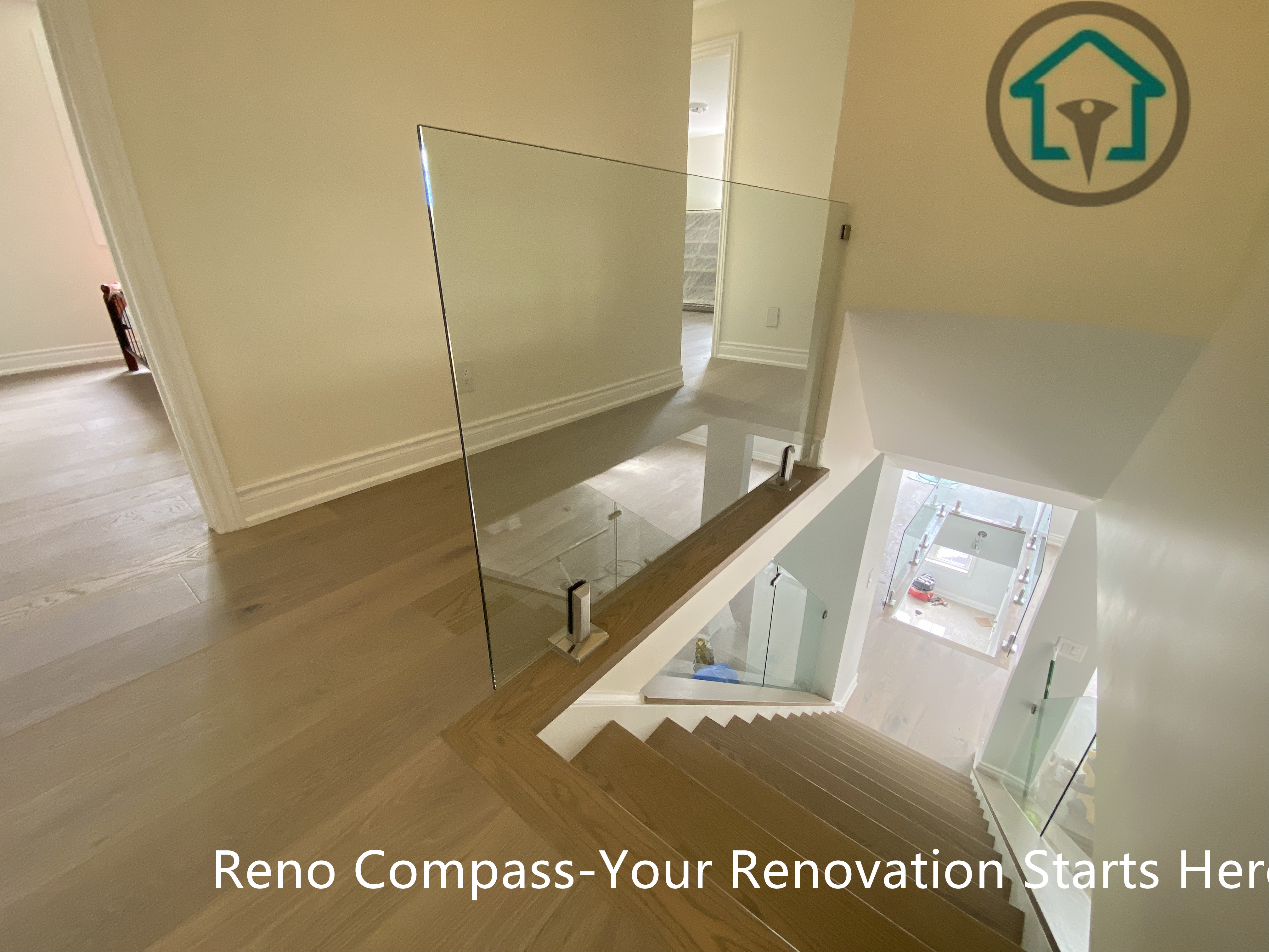 This stair landing highlights clean architectural lines and consistent flooring throughout the home. Glass guards and open sightlines maintain visual continuity while ensuring safety and a polished, modern finish.