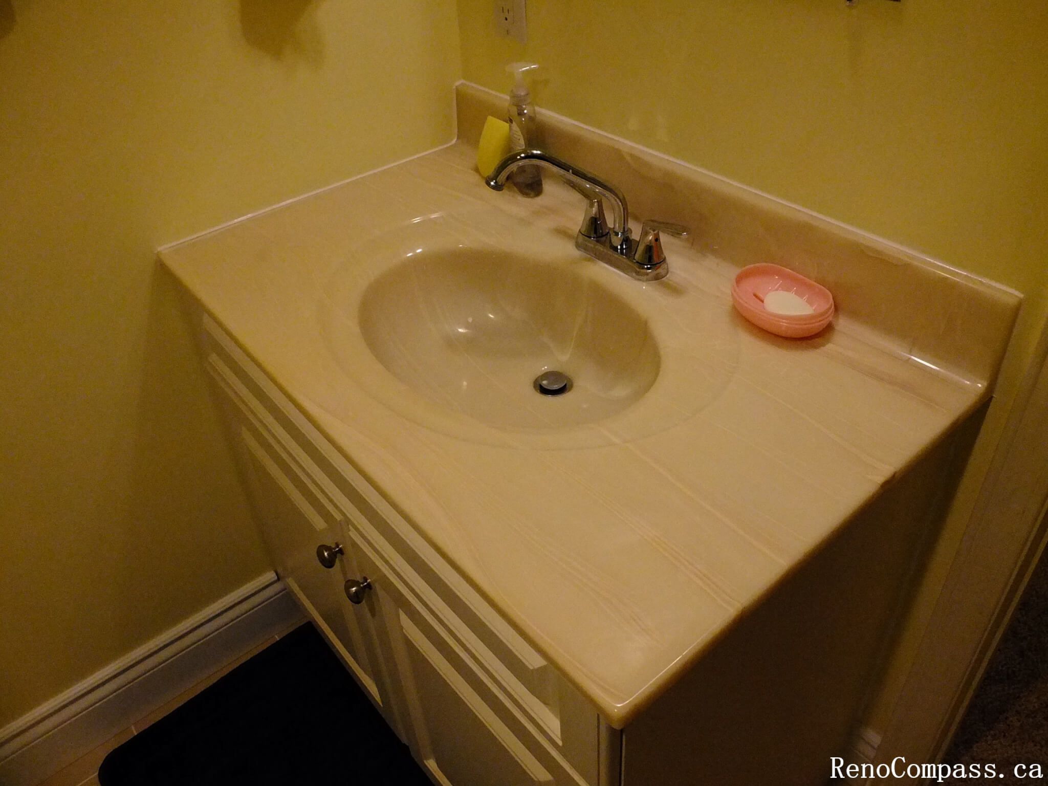 This Mississauga bathroom renovation includes the installation of a clean and functional vanity sink with integrated countertop design. The bathroom vanity features a classic neutral finish, chrome faucet fixtures, and practical storage cabinetry that improves both organization and everyday usability. The compact layout maximizes space efficiency while maintaining a bright and tidy appearance. With durable materials and simple modern styling, this vanity upgrade contributes to a comfortable and well-organized bathroom environment.