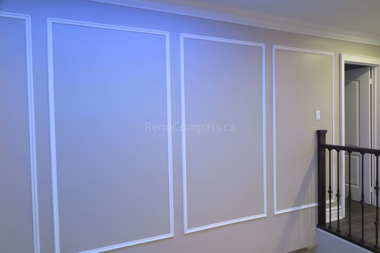 This Markham interior renovation features elegant custom wall panel molding that enhances the home's architectural detail and modern aesthetic. Clean trim lines, neutral wall tones, and quality finishing create a refined and sophisticated interior space that complements the staircase and upper hallway area. Completed by Reno Compass, a professional renovation contractor specializing in custom interior finishing and full home renovations across Markham and the Greater Toronto Area.