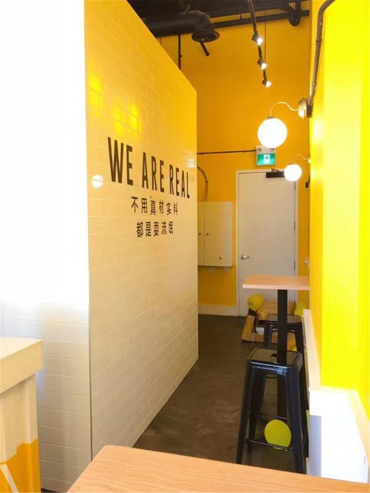 Finished seating area of the HEY FruitTea commercial renovation, featuring warm lighting, clean finishes, and a welcoming layout designed for customer comfort and brand experience.