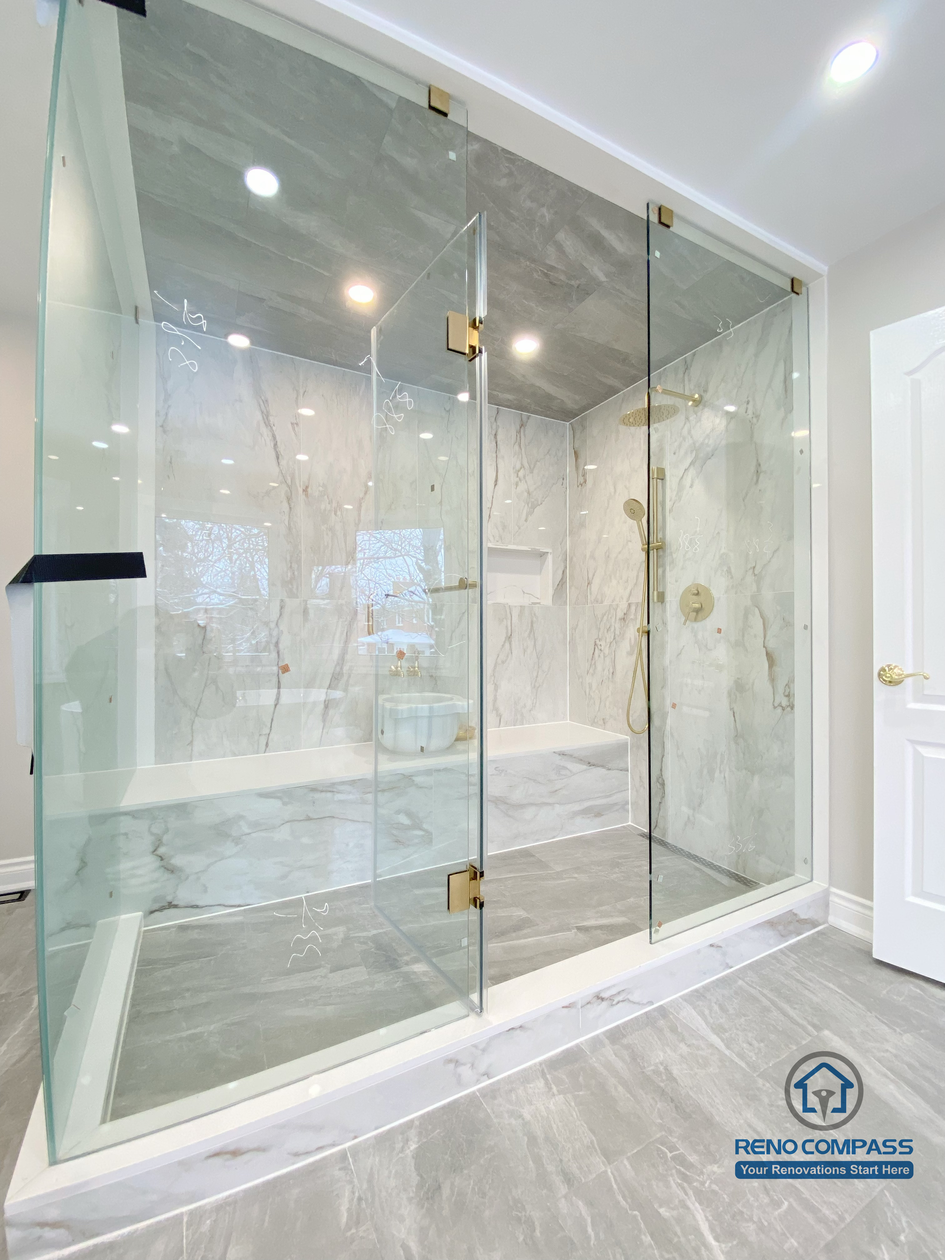 This Richmond Hill bathroom renovation showcases a bright and elegant design featuring a frameless glass shower enclosure