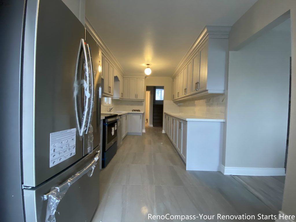 This Mississauga interior renovation showcases a modern U-shaped kitchen layout featuring custom shaker-style cabinetry, quartz countertops, and stainless steel appliances. The design emphasizes efficient workflow, generous storage, and a clean visual balance. Soft neutral tones and full-height cabinetry enhance brightness and functionality, making this kitchen renovation ideal for long-term everyday living.
