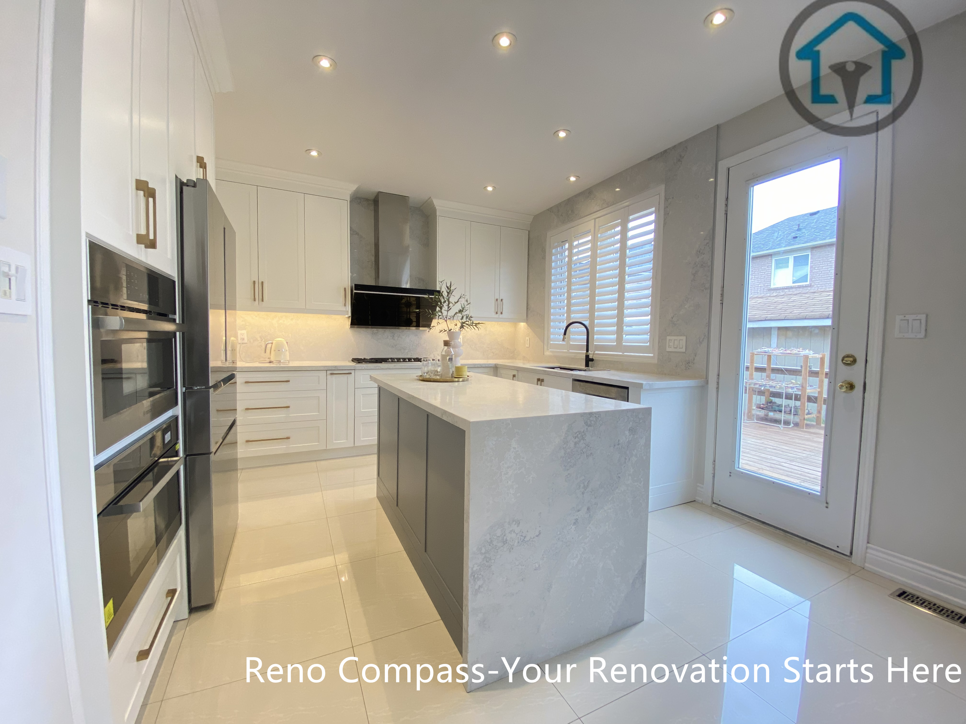 This image highlights the central waterfall island and the abundance of natural light in this Markham kitchen renovation. Positioned near large windows and a rear access door, the island becomes both a functional workspace and a visual focal point. Clean cabinetry lines, reflective flooring, and balanced lighting enhance the sense of openness and flow. Designed and completed by Reno Compass, this kitchen renovation demonstrates a thoughtful approach to space planning for modern homes in Markham.