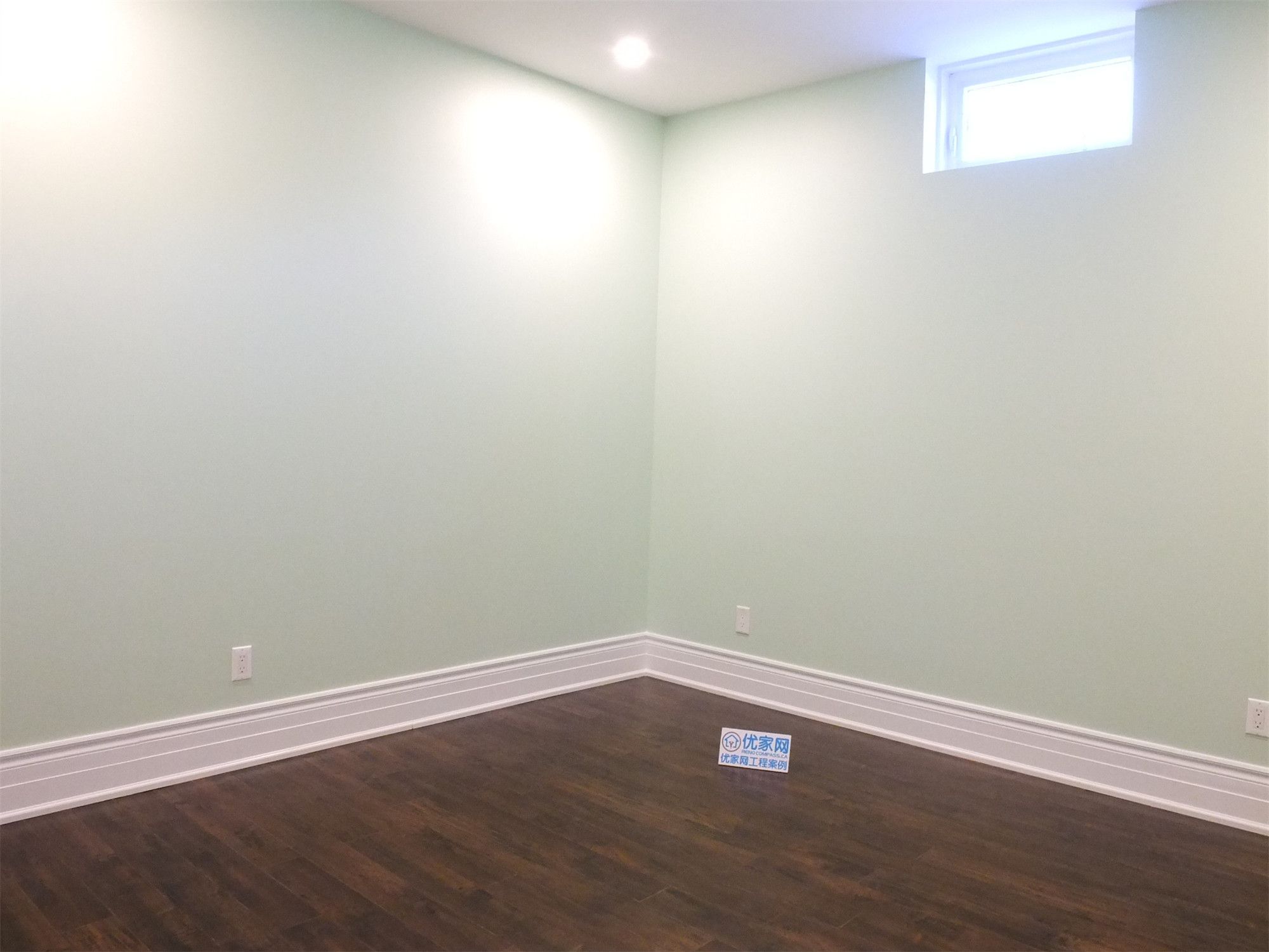 This Richmond Hill basement renovation features a newly finished bedroom space with rich hardwood flooring, smooth neutral walls, and modern recessed pot lighting. A bright basement window brings in natural light, creating a comfortable and inviting environment. The clean layout and durable finishes make this room ideal for guest accommodation, rental use, or extended family living, professionally completed to enhance both functionality and home value.