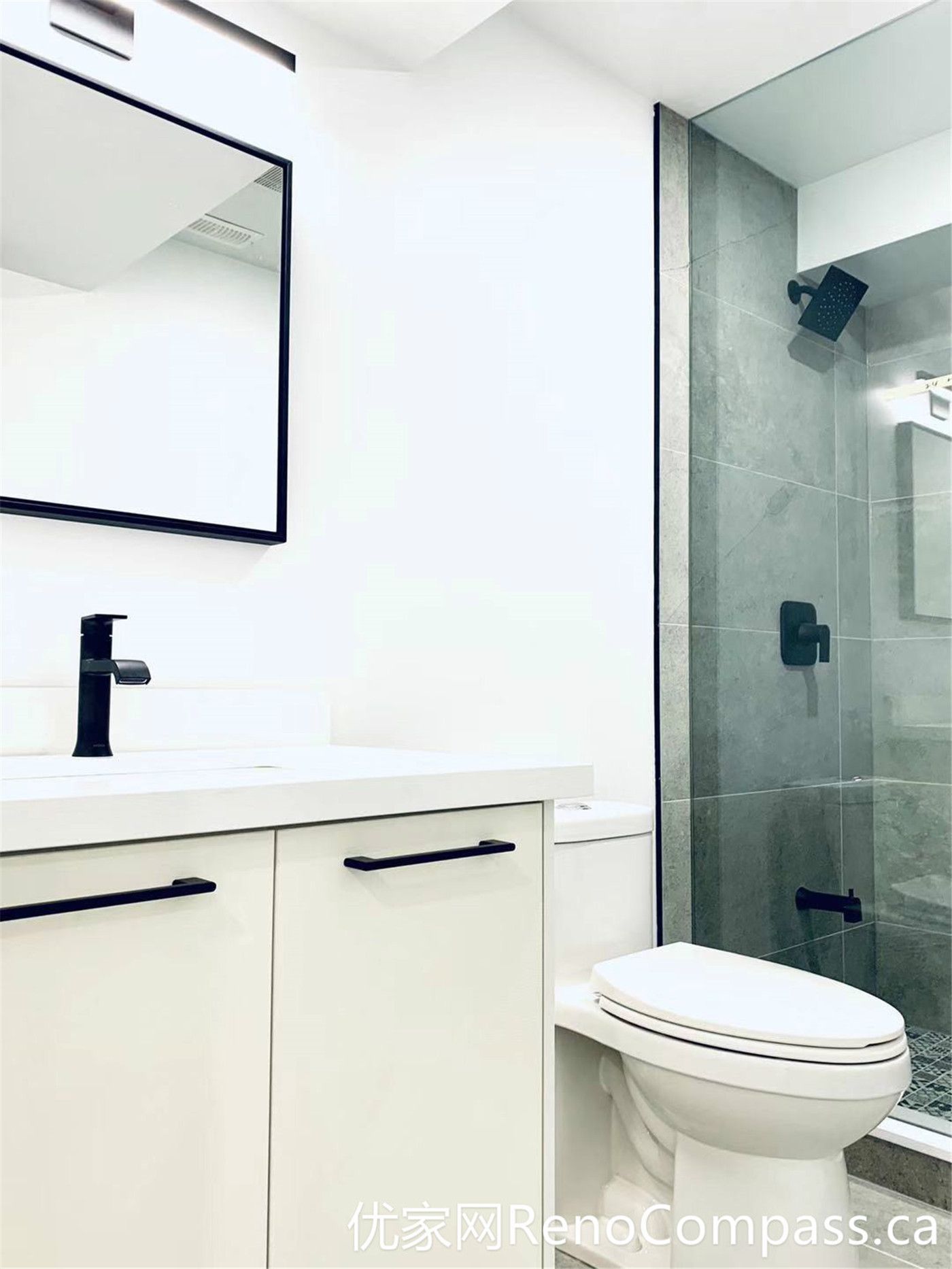This Markham full home renovation features a clean and modern bathroom design with a frameless glass shower, matte black fixtures, and a minimalist vanity. The neutral color palette and efficient layout enhance both functionality and visual appeal, delivering a bright and contemporary space ideal for everyday use.