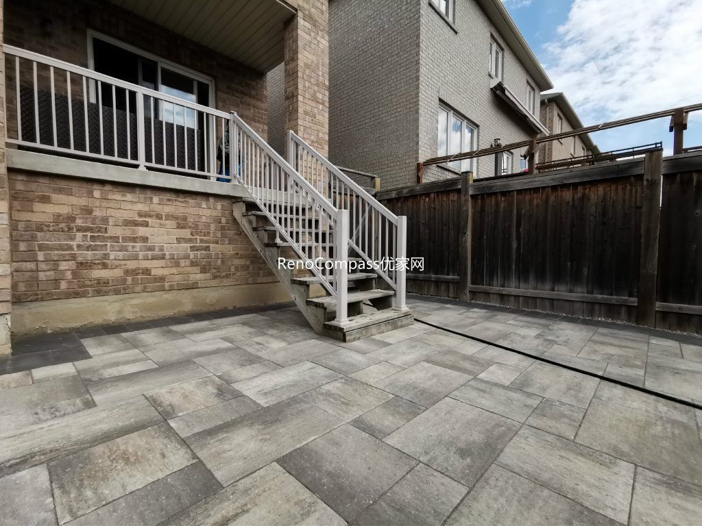 Beautiful backyard interlocking patio in Vaughan designed for comfort and style. Features durable grey stone pavers with a smooth finish, perfect for gatherings and relaxing under the deck. Expertly built by Reno Compass for long-lasting performance.