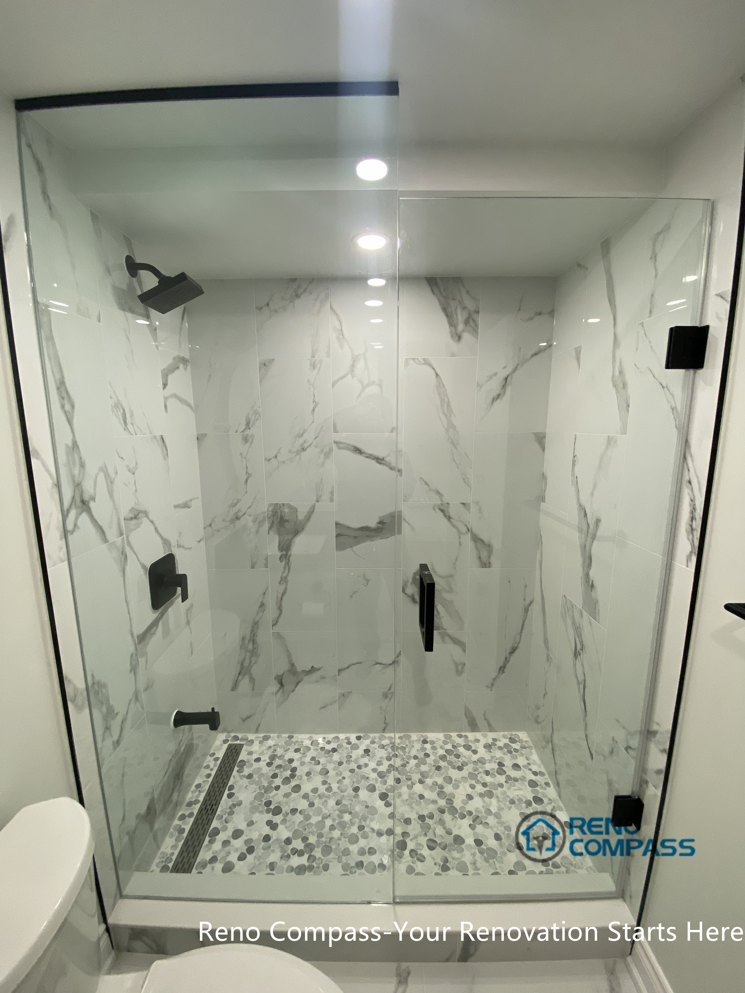 This image features a modern basement bathroom shower area renovated in Aurora. The walk-in shower design, neutral tile finishes, and clean detailing enhance both functionality and visual clarity, creating a durable and comfortable basement bathroom solution.