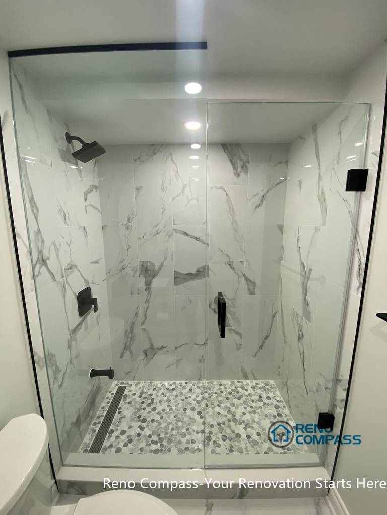 This image features a modern basement bathroom shower area renovated in Aurora. The walk-in shower design, neutral tile finishes, and clean detailing enhance both functionality and visual clarity, creating a durable and comfortable basement bathroom solution.