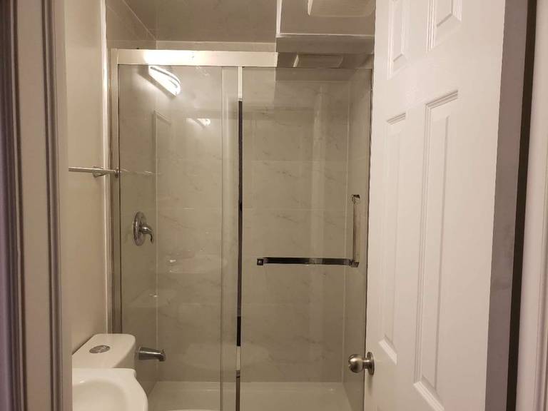 This Markham basement bathroom renovation features a modern glass-enclosed shower with clean tile finishes and updated plumbing fixtures. The space is designed for practicality and durability, incorporating a clear sliding glass door, neutral wall tiles, and efficient lighting to enhance brightness in the basement environment. Compact layout planning ensures comfortable use while maintaining a clean and contemporary look. This professionally completed basement bathroom highlights quality workmanship and thoughtful design, making it a functional addition to a fully finished basement in Markham.
