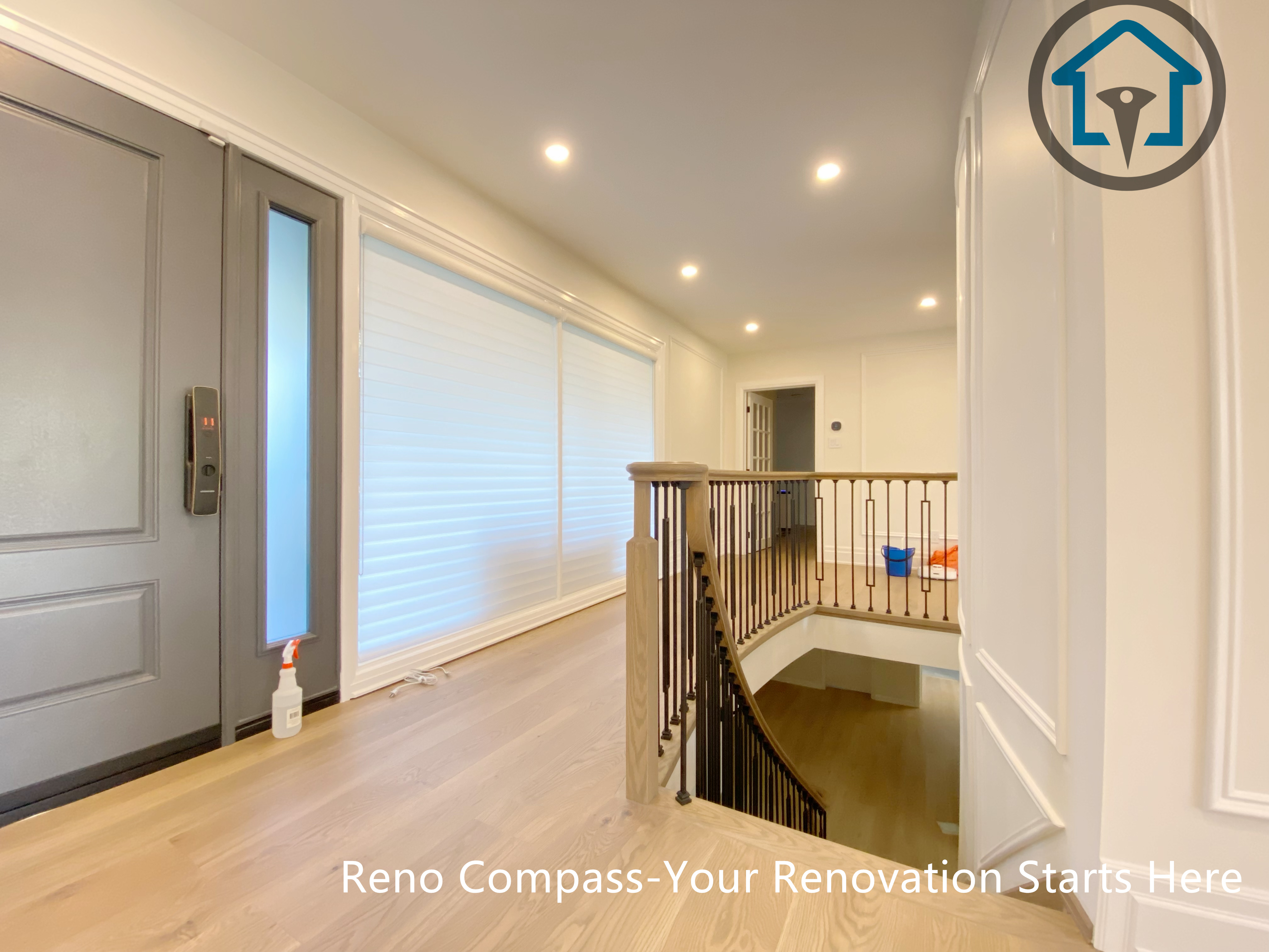 This North York house interior renovation features a refined upper hallway with custom wall paneling, wide-plank wood flooring, and a modern staircase railing. Recessed lighting and clean sightlines enhance circulation between levels, creating a bright and cohesive transition space that complements the home’s overall interior upgrade.