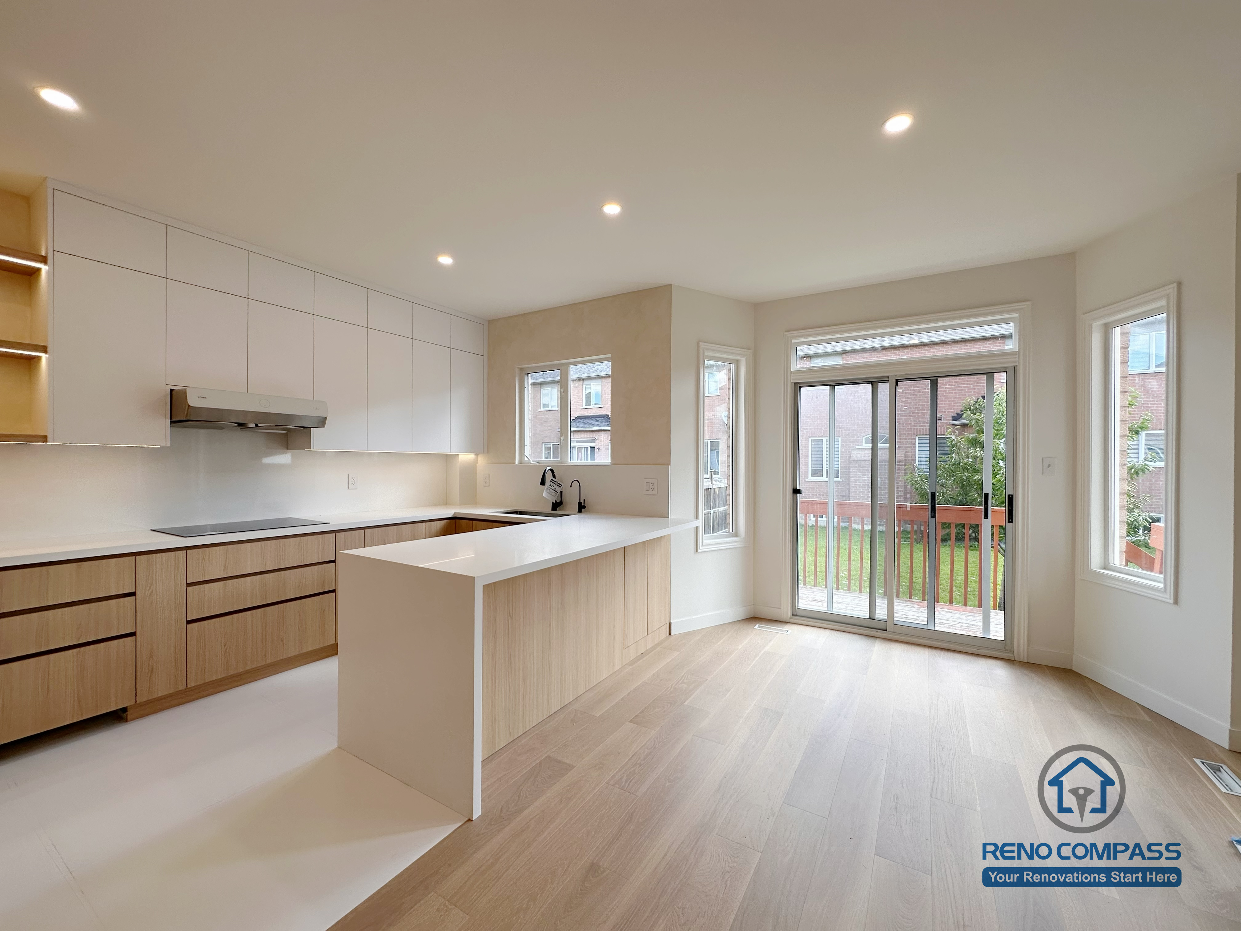 Open-concept kitchen renovation in Markham featuring a large island, custom cabinetry, and seamless connection to the dining area. The layout enhances natural light, improves circulation, and creates a bright, functional space suitable for everyday cooking and family gatherings.
