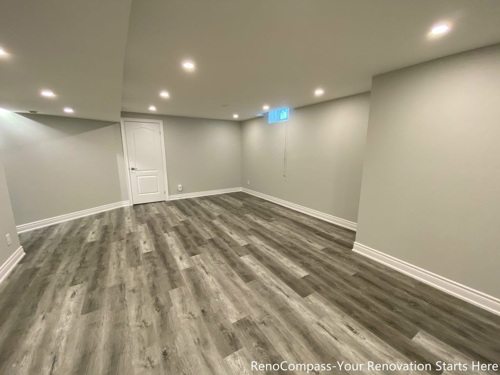 This Richmond Hill basement renovation features a clean modern design with high-quality vinyl flooring, smooth ceiling finishing, and recessed pot lights for a bright and spacious feel. Completed by professional Toronto renovation company Reno Compass Inc., the project transforms the basement into a functional and comfortable living space ideal for family use, rental, or entertainment. The neutral wall tones and durable flooring enhance both aesthetics and long-term value.