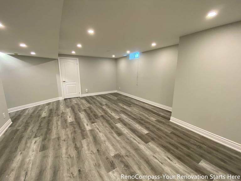 This Richmond Hill basement renovation features a clean modern design with high-quality vinyl flooring, smooth ceiling finishing, and recessed pot lights for a bright and spacious feel. Completed by professional Toronto renovation company Reno Compass Inc., the project transforms the basement into a functional and comfortable living space ideal for family use, rental, or entertainment. The neutral wall tones and durable flooring enhance both aesthetics and long-term value.