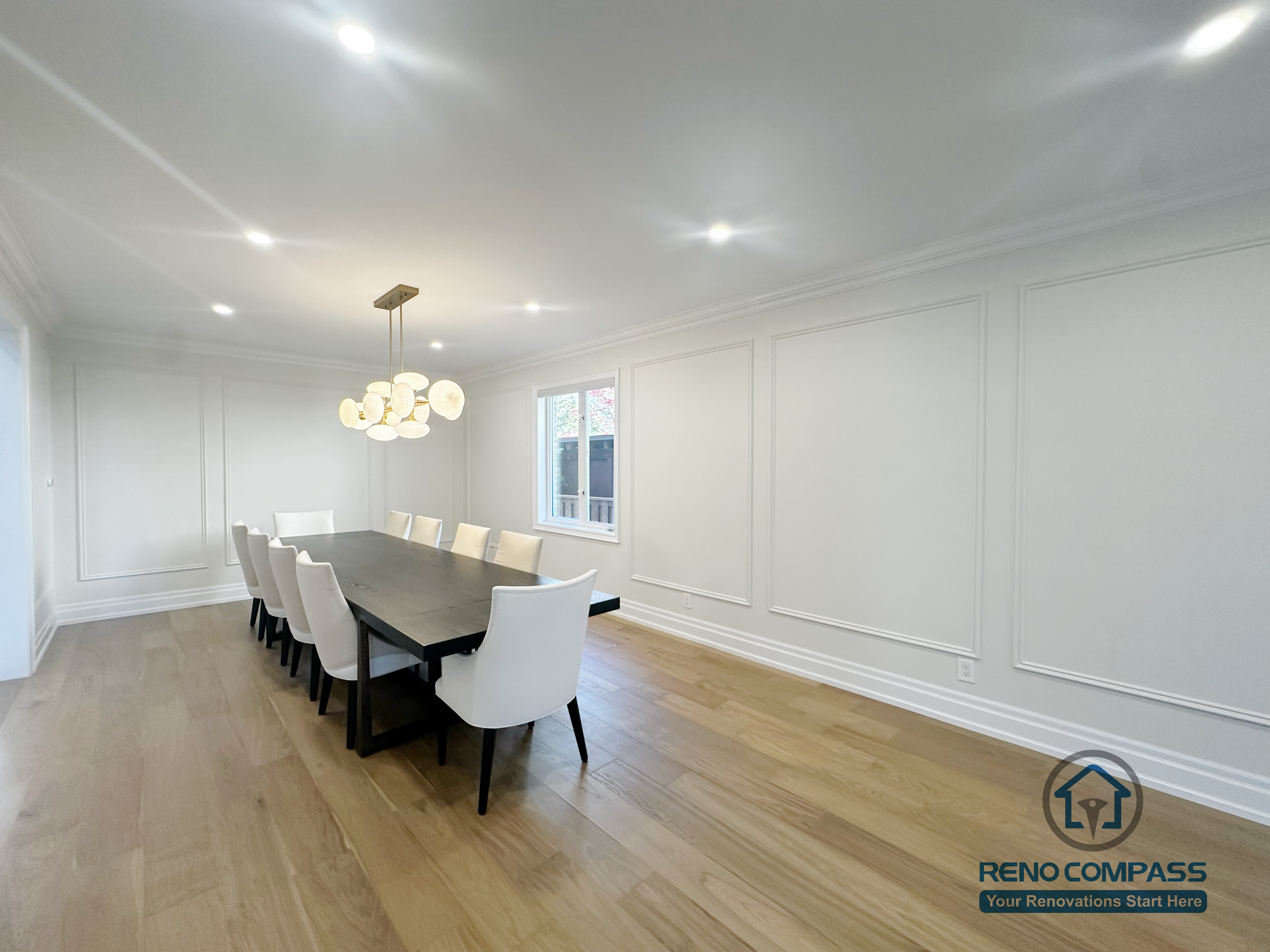This image highlights a completed flooring renovation in North York, featuring hardwood flooring installed throughout a formal dining area. The natural wood finish adds warmth and continuity to the space while complementing the clean wall paneling and recessed lighting. The flooring installation enhances durability and everyday usability, providing a smooth visual transition between dining and adjacent living areas. This project reflects a careful approach to hardwood flooring selection and installation for North York homes.