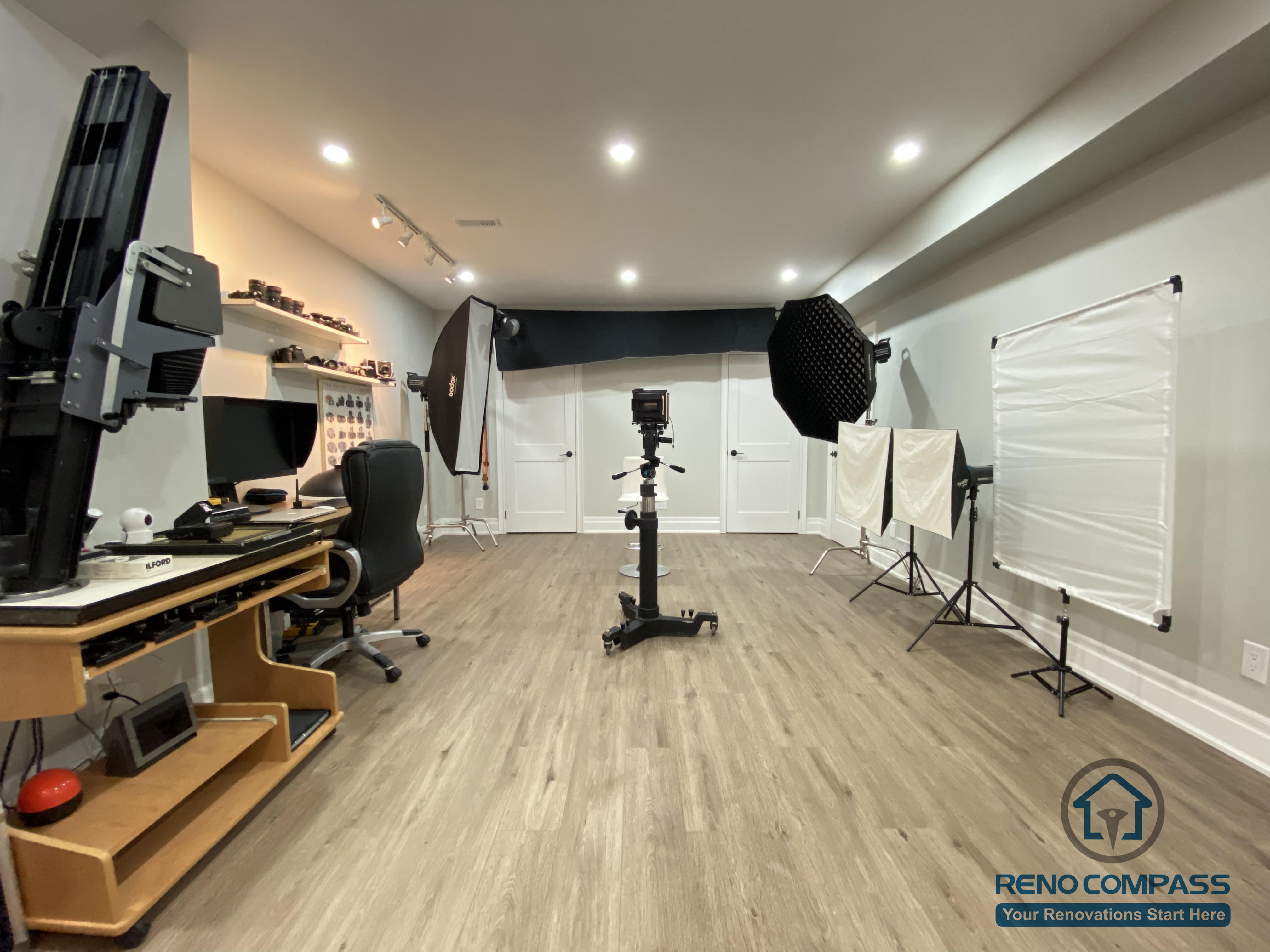 This Oakville basement renovation features a professionally configured photography studio with ample open floor space and controlled lighting conditions. The layout supports large backdrops, studio lighting equipment, and camera setups, while recessed ceiling lights provide consistent ambient illumination. Durable wood flooring and clean wall finishes create a neutral, adaptable environment for professional shoots and creative production. As a trusted Toronto renovation company, Reno Compass designs basement studios that meet the spatial, lighting, and flexibility needs of serious photographers and content creators.
