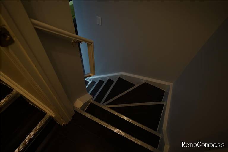 Updated basement staircase featuring fresh trim work, clean wall finishes, and improved lighting. This renovation enhances safety and modernizes the transition between floors, showcasing quality craftsmanship in a Mississauga home remodel.
