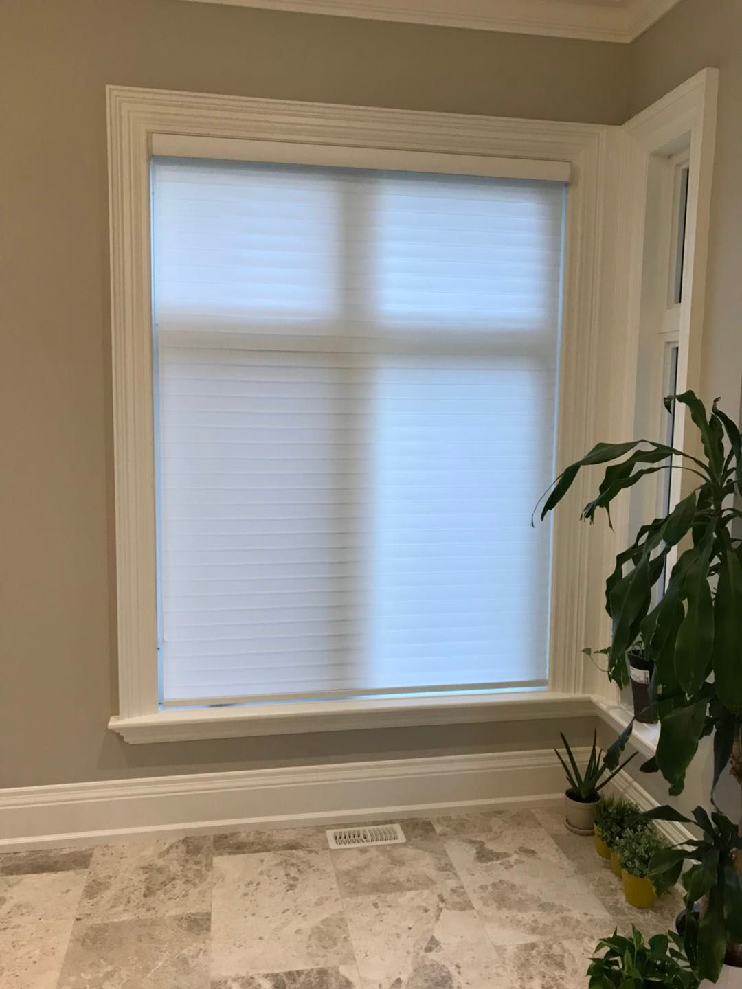 Custom zebra blinds installation in Toronto dining room by professional Toronto renovation company Reno Compass Inc. Featuring dual-layer light filtering shades, clean white window trim, modern chandelier lighting, and elegant wall panel detailing. This window treatment upgrade enhances privacy, natural light control, and interior aesthetics with a sleek and contemporary finish.
