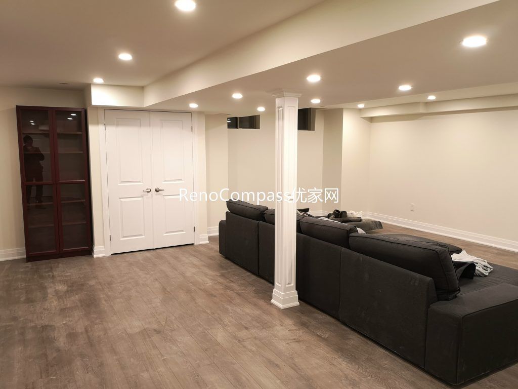 Finished Richmond Hill basement living space featuring open layout, new flooring, modern pot lights, structural column detailing, and custom storage. Renovated by Reno Compass Inc., this basement upgrade enhances comfort, brightness, and multi-functional living space for homeowners.