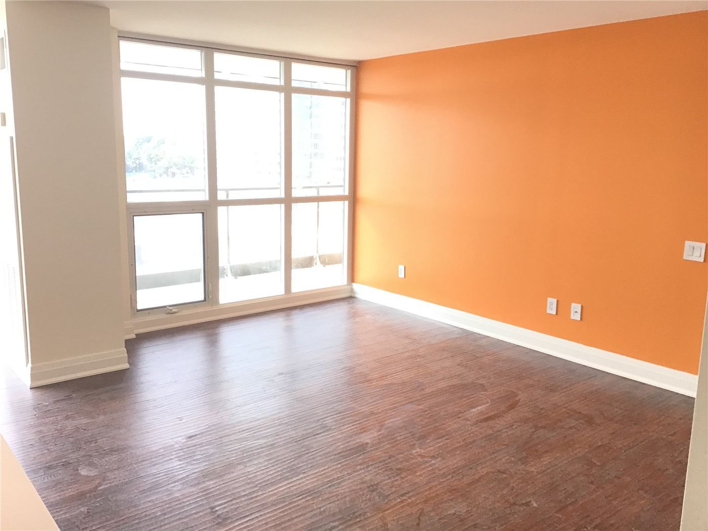 Bright and modern condo interior renovation in North York featuring upgraded flooring, fresh wall finishes, and large floor-to-ceiling windows that maximize natural light and city views. This clean and functional living space reflects contemporary condo design and quality workmanship. Completed by a professional Toronto renovation company, Reno Compass Inc., specializing in full condo and interior renovation projects.