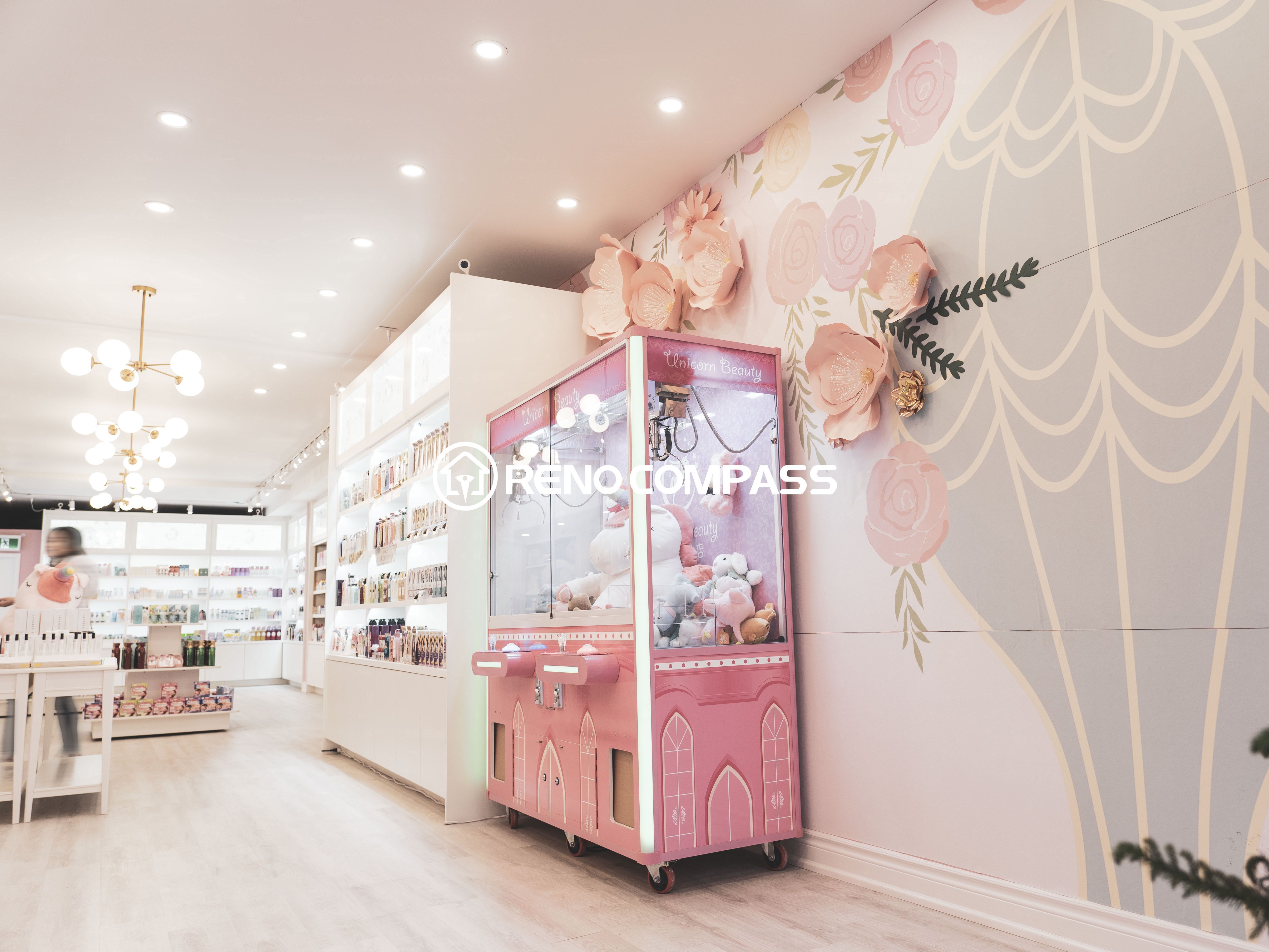 This Toronto beauty store commercial renovation showcases a bright and modern retail space designed for customer experience. The store features elegant wall displays, organized cosmetic shelving, warm lighting, and a decorative claw machine area that enhances the playful and stylish shopping environment. Completed by a professional Toronto renovation company, the design combines aesthetics with functionality to create an inviting beauty retail space.