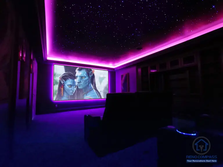 Custom home theatre renovation in Aurora featuring a star ceiling, ambient LED lighting, and a large projection screen for an immersive cinematic experience.