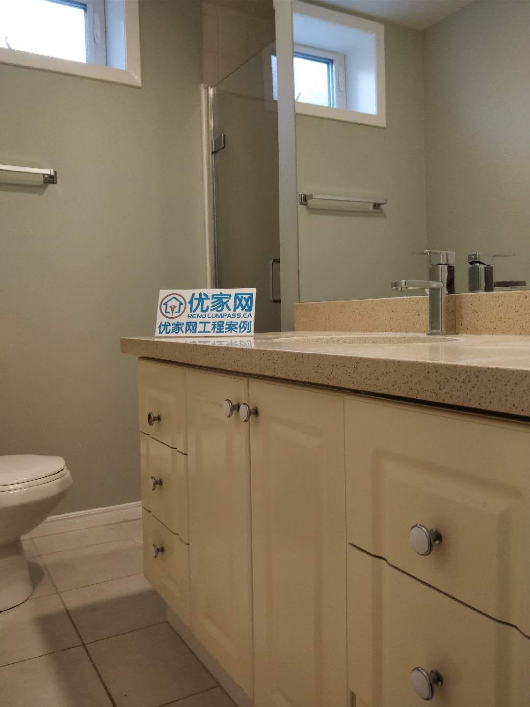 White bathroom vanity with a beige quartz countertop, undermount sink, and chrome faucet installed by Reno Compass in a Scarborough home.